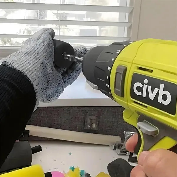 Person using a yellow and black drill labeled 'civb' with a window and blinds in the background.