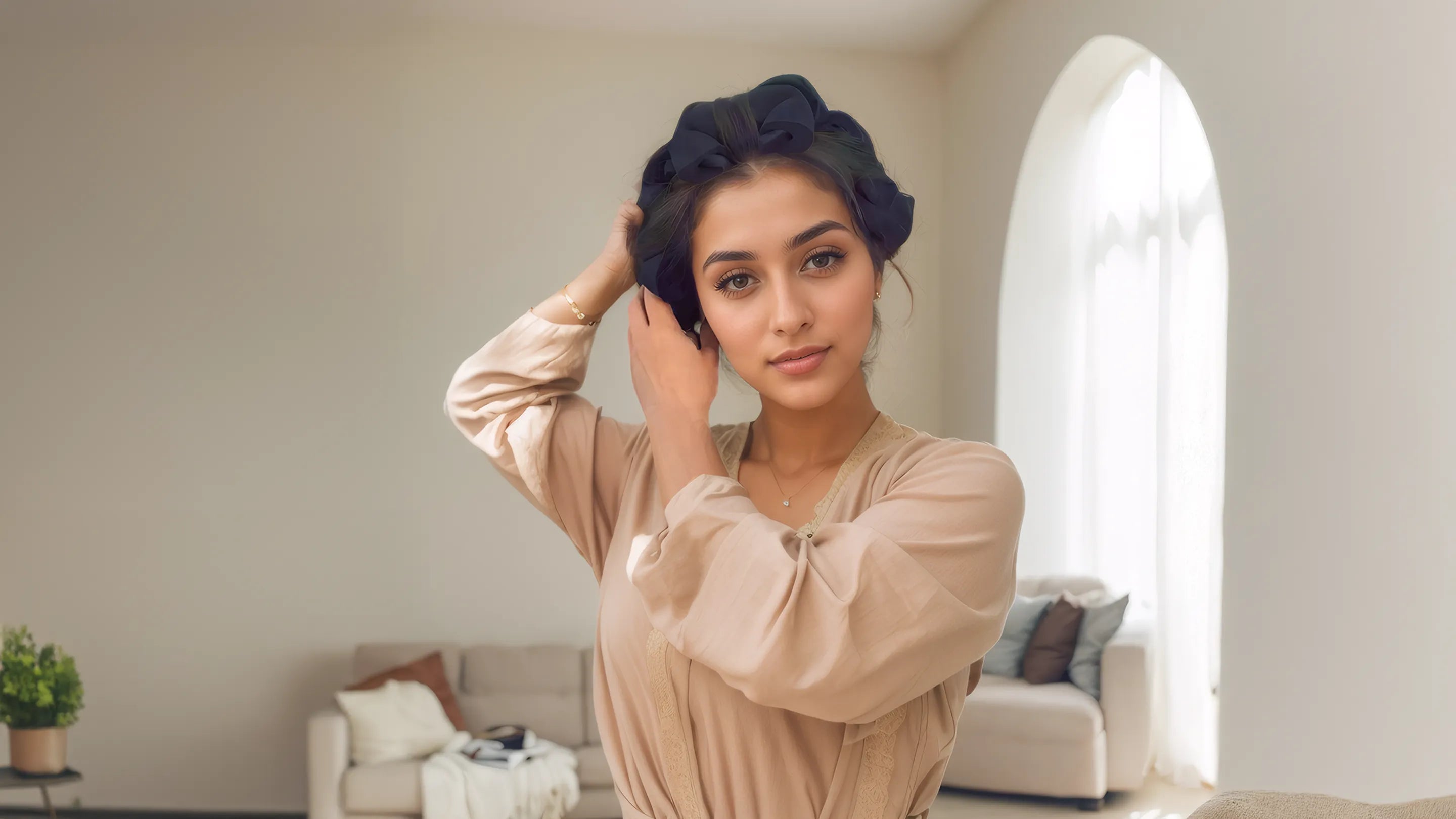 Woman adjusting her hair in a living room setting